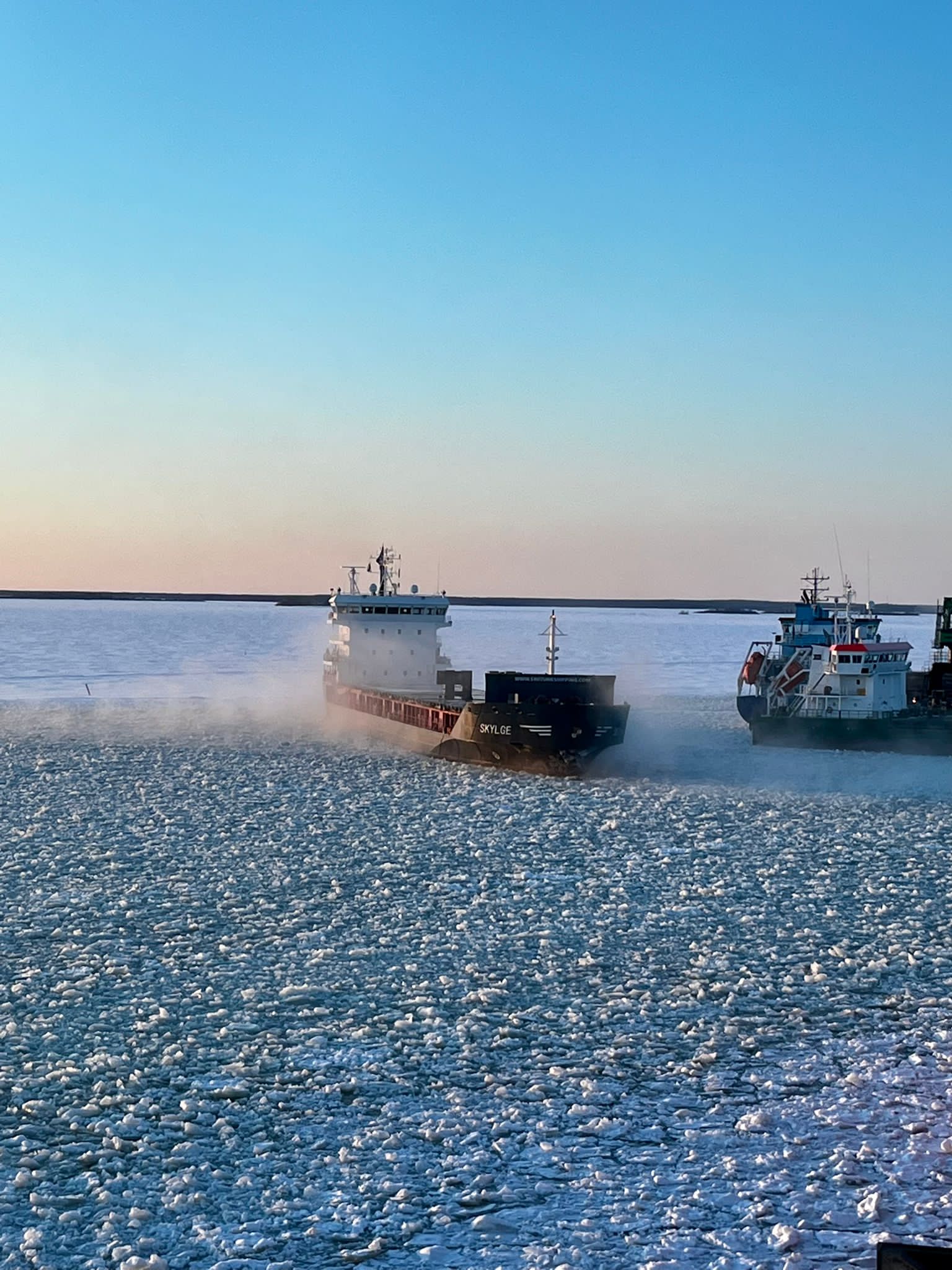 cargo ships working their way through the ice sea in Tornio