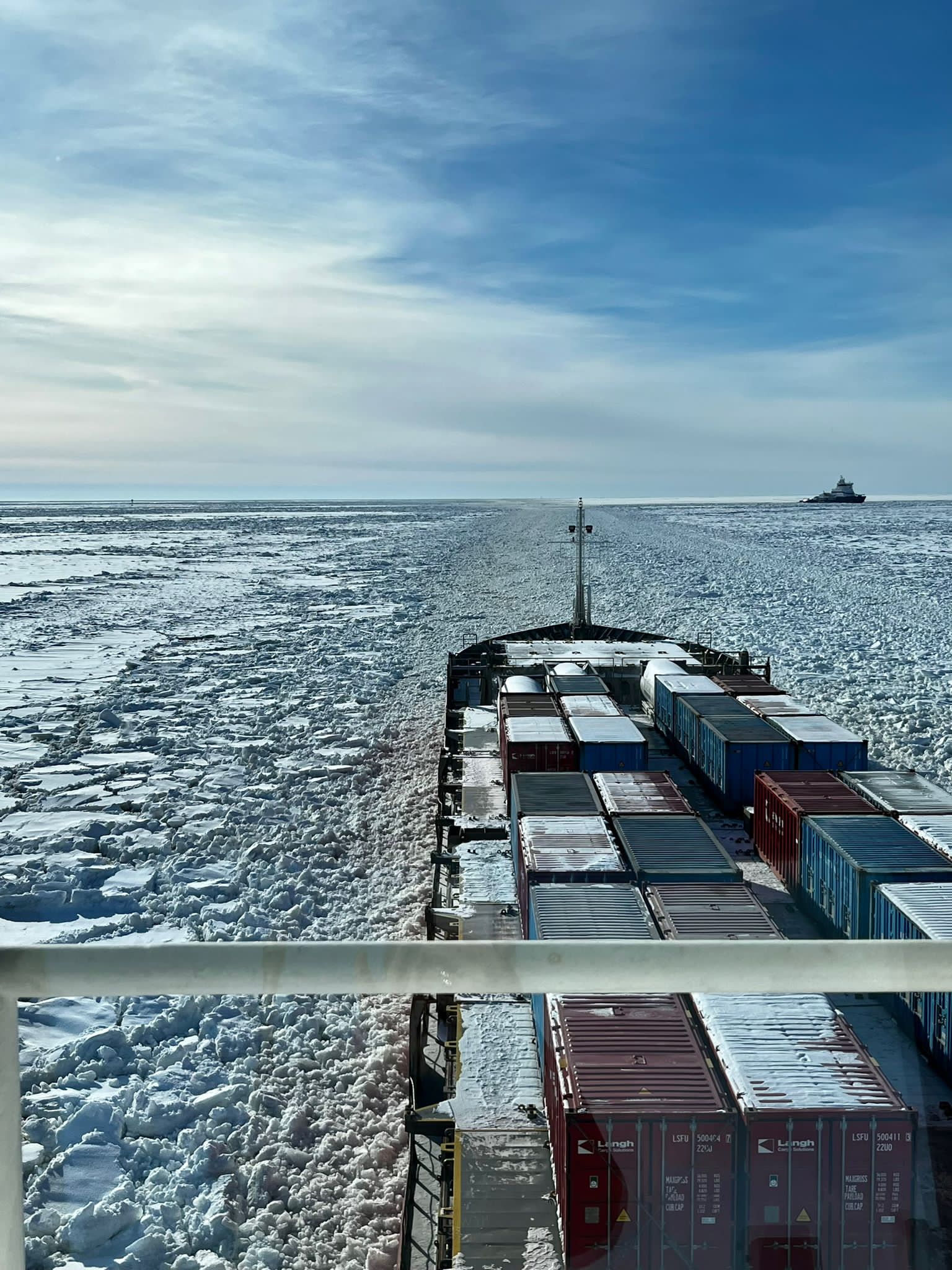 cargo ship traveling through breaking ice in Gulf of Bothnia
