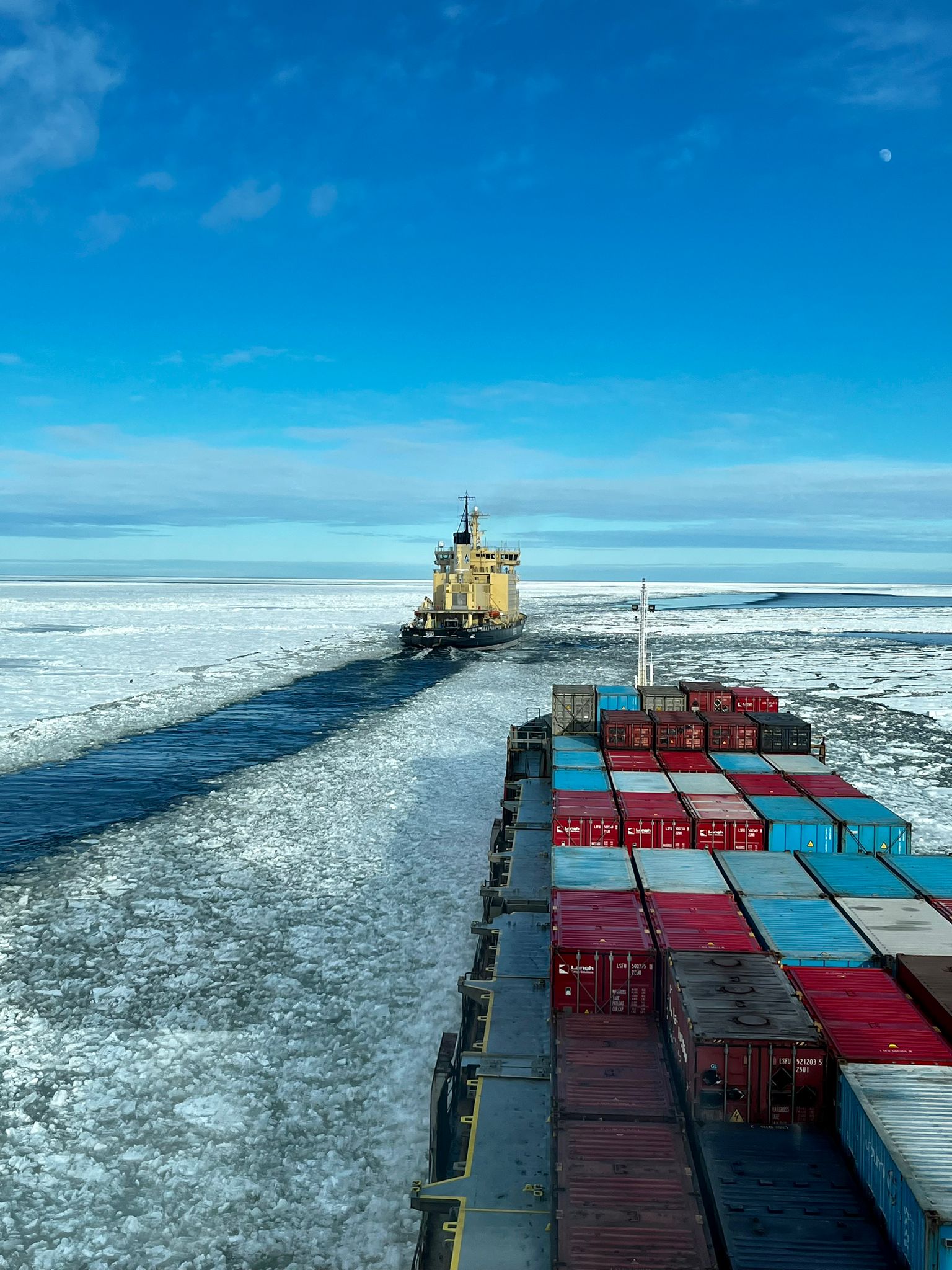 cargo ship traveling through ice in Gulf of Bothnia with other ship in view