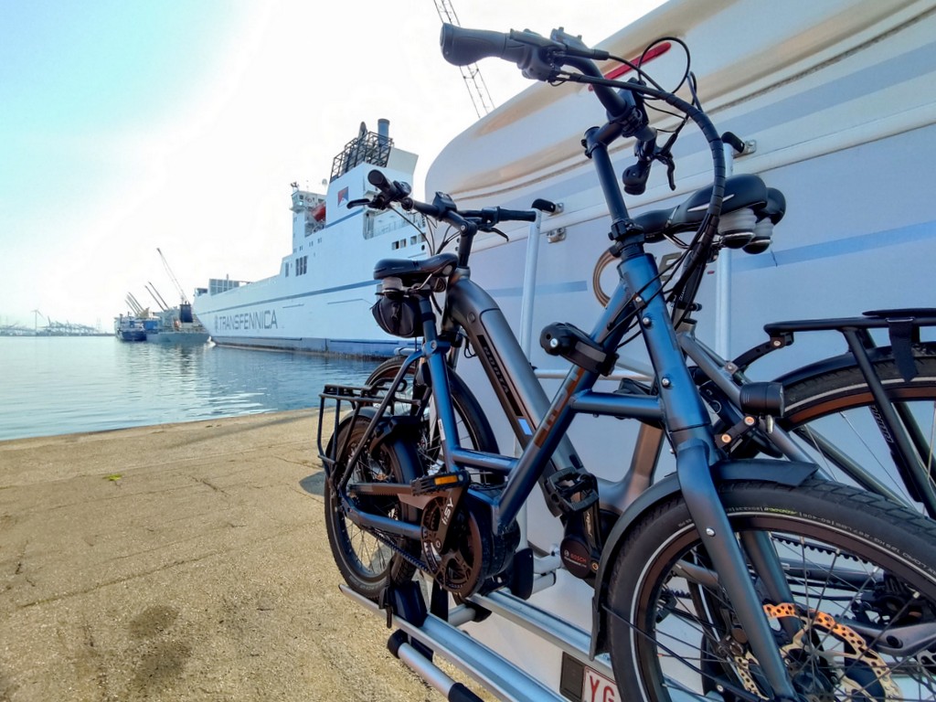 Bicycles attached to camper with view of Timca ship at the port of Antwerp
