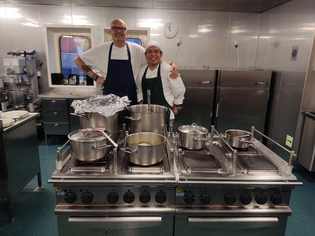 Cooks Auke (left) and Jim in their galley aboard the ship Timca to Finland