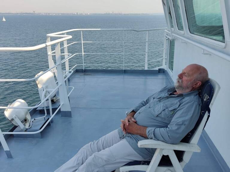 Pol takes a siesta on the spacious deck behind the bridge of the cargo ship Timca to Finland
